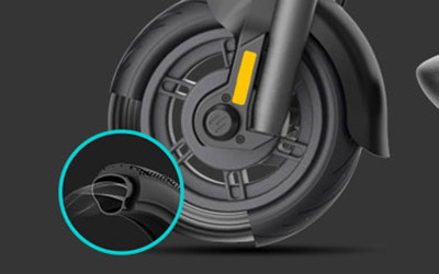 Close-up image of Electric scooter Inmotion S1 front wheel and pneumatic tire.