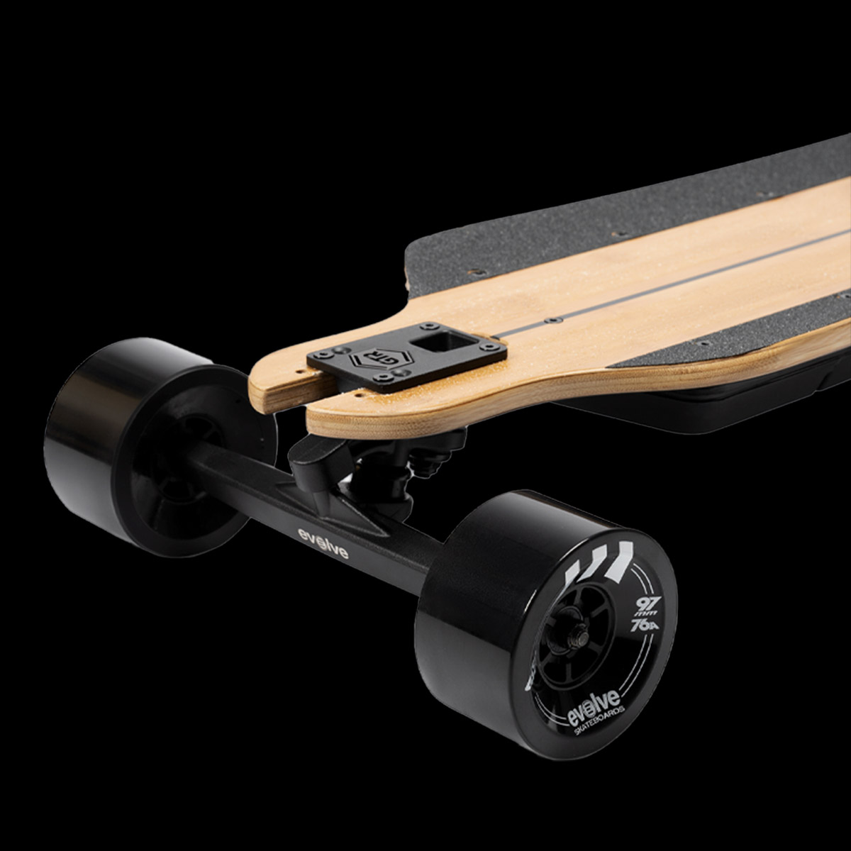 Close-up of Evolve GTR 2 Carbon All Terrain electric skateboard showing front street wheels and bamboo deck layer