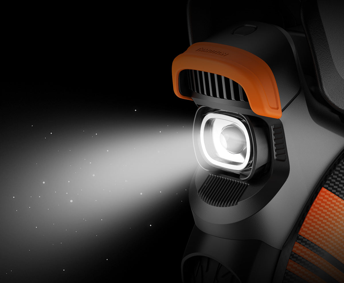 Close-up of the Inmotion V11Y electric unicycle’s 1500-lumen headlight illuminating in the dark.