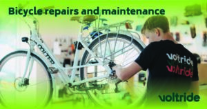 Technician repairing or maintaining an electric bicycle - Voltride promotion banner for repair works.